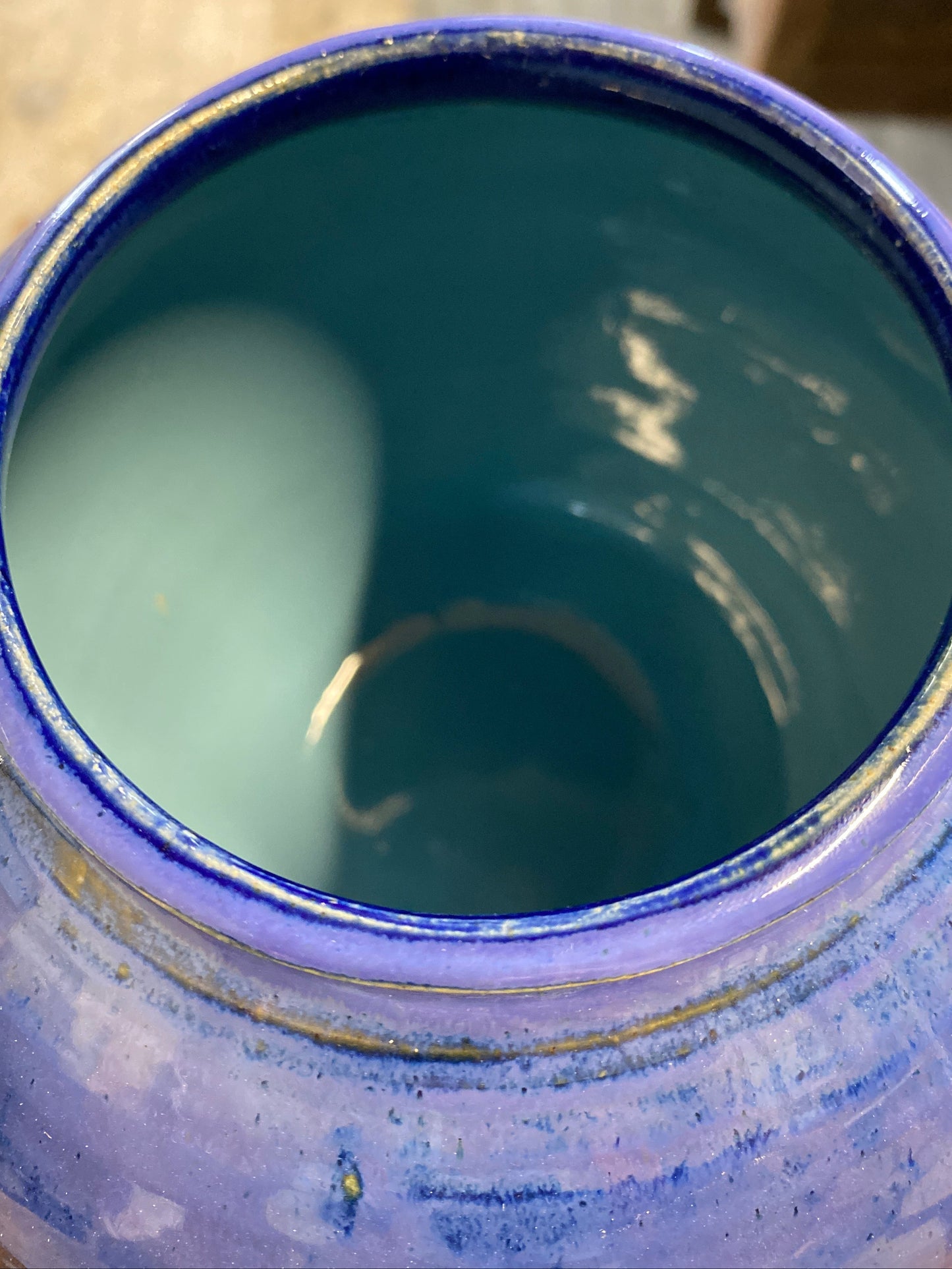 Close-up of a blue ceramic jar with a textured surface.