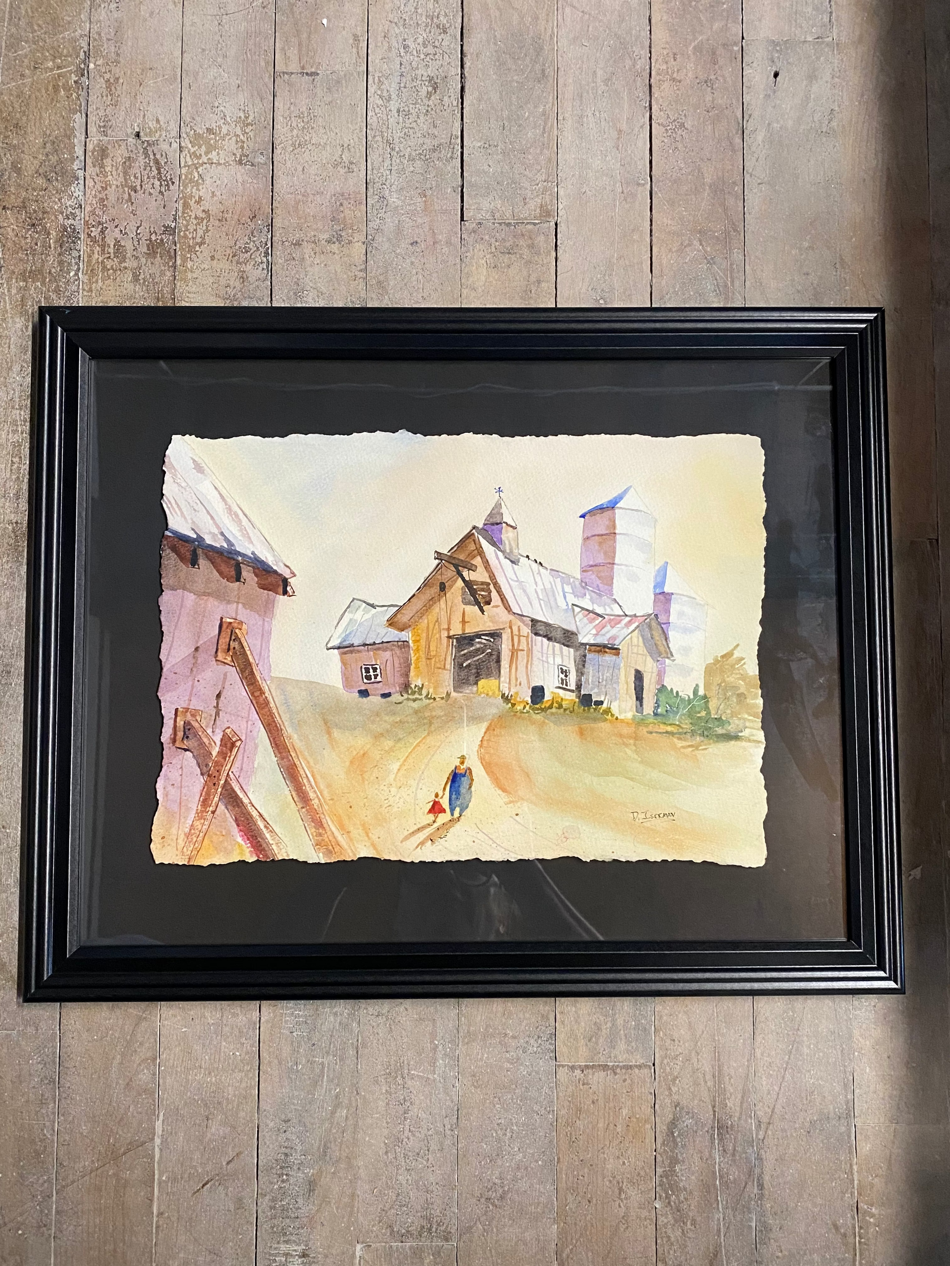 Framed artwork on a wooden wall